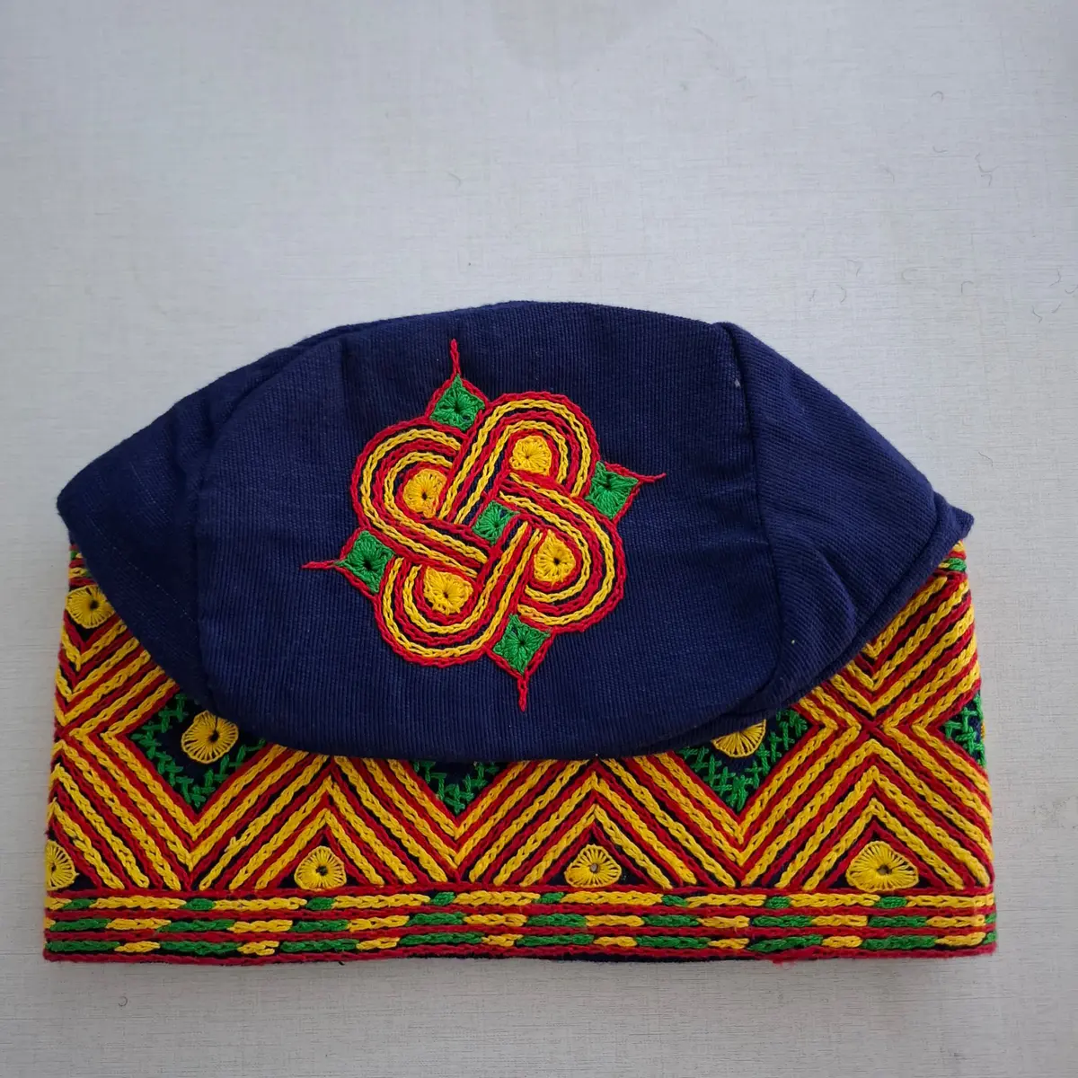 A blue multi-coloured Aso Oke embroided cap