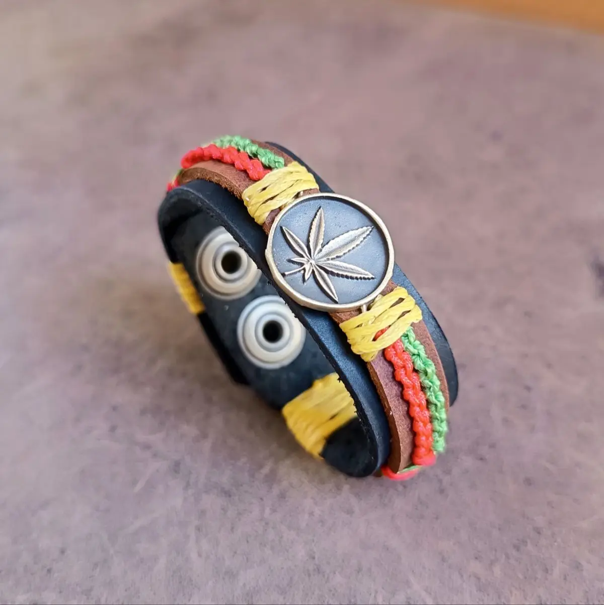 Handmade Rasta Leather Cuff Bracelet with leaf pendant and woven wax cords inJamaican colors