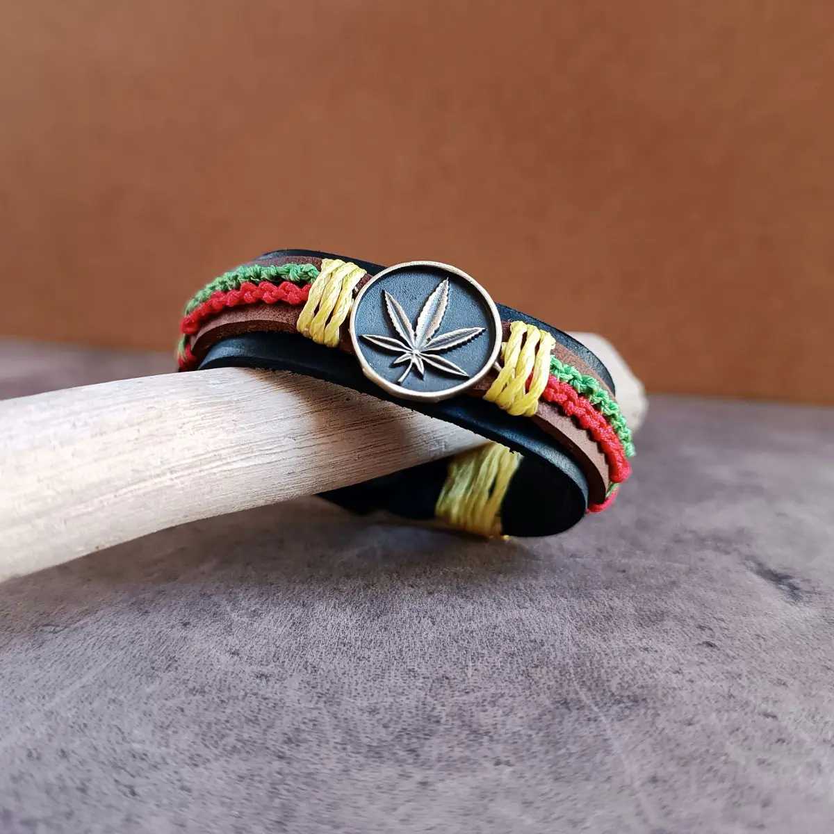 Handmade Rasta Leather Cuff Bracelet with leaf pendant and woven wax cords in Jamaican colors