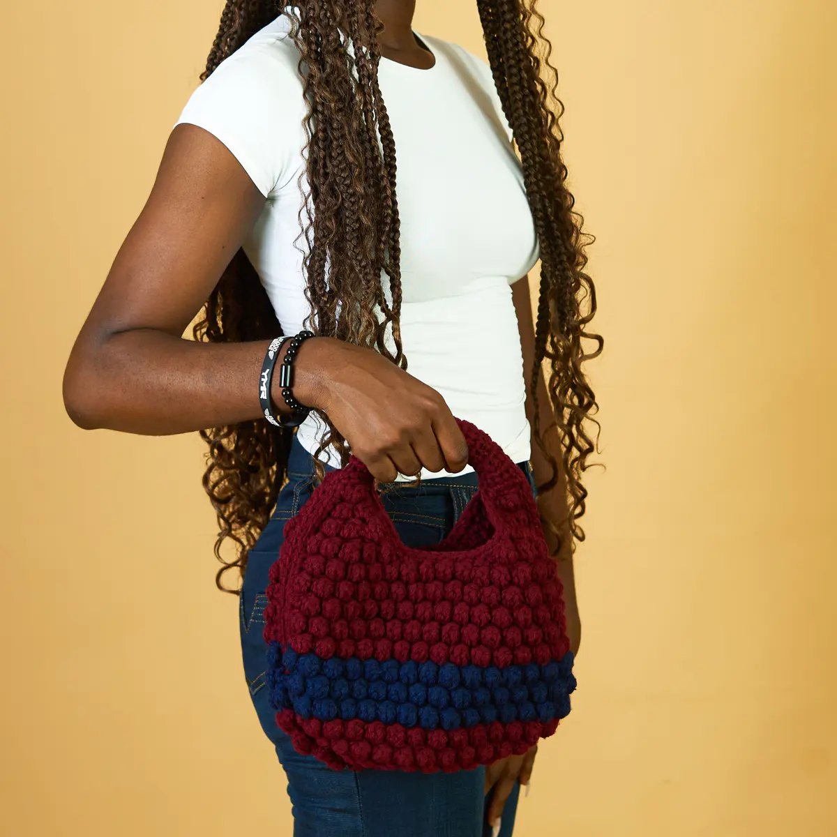 This petite knitted bag is the perfect blend of charm and functionality. Handcrafted with care, its compact size makes it ideal for carrying just the essentials — phone, keys, cards, and a touch of lipstick. Soft to the touch with a beautifully textured knit design, this bag adds a cozy, stylish accent to any outfit. Lightweight and easy to carry, it's your go-to accessory for casual outings, coffee dates, or minimalist everyday style.