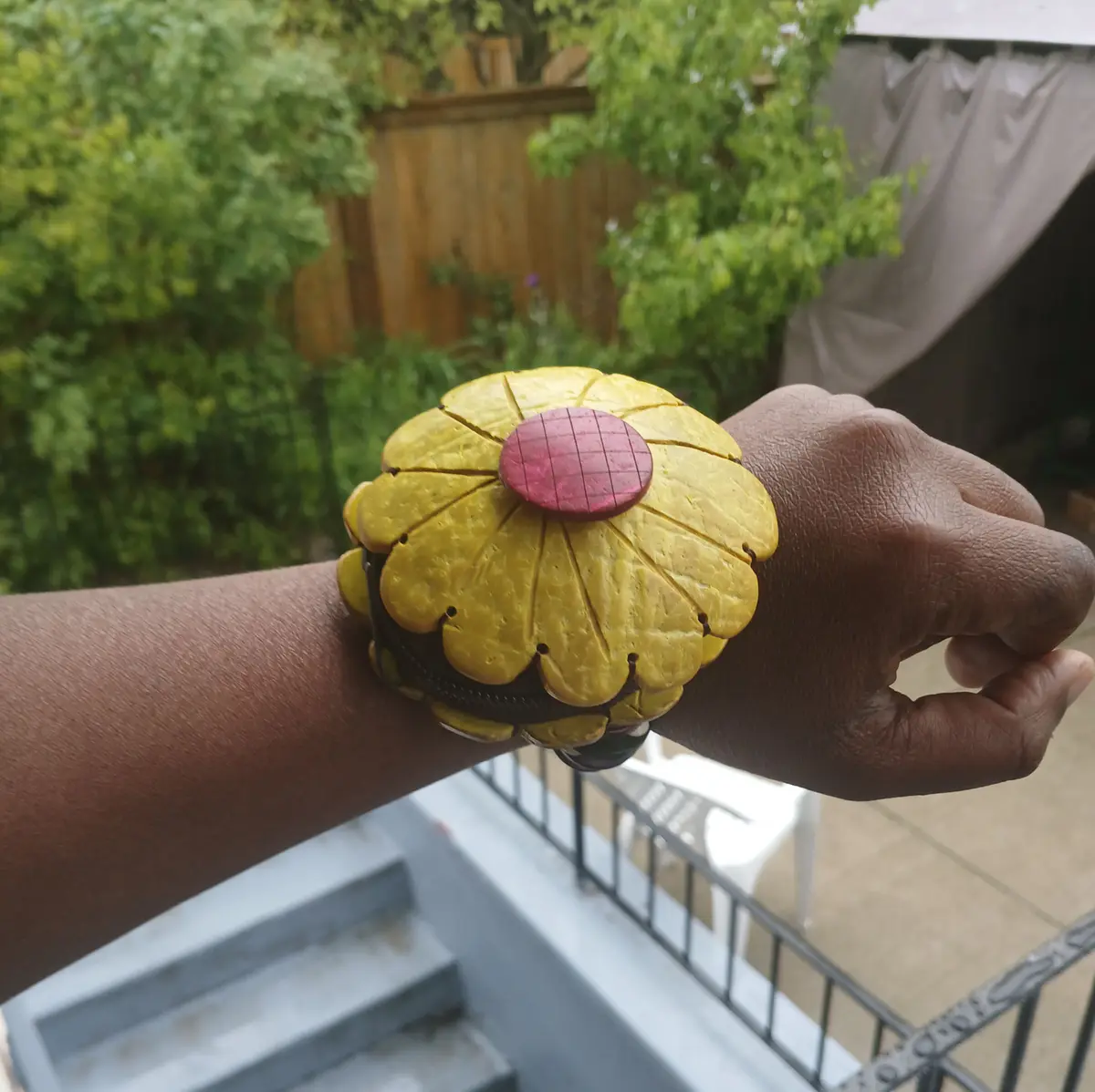 Someone wearing a handmade wooden coin purse for kids