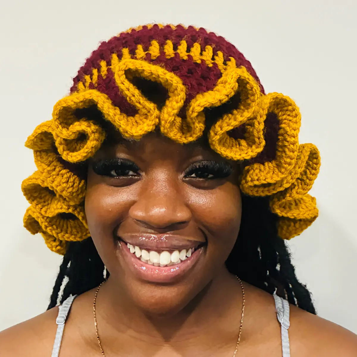 Wearing a Burgundy & Mustard Yellow crochet ruffled hat for women