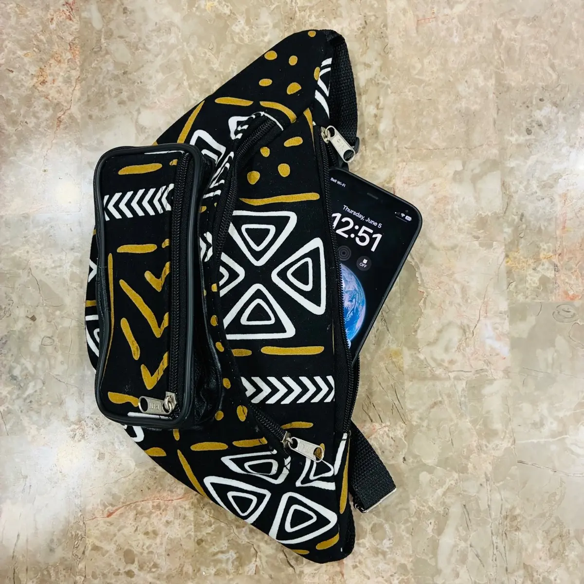A handmade mudcloth-inspired african print fanny pack showcasing space for phone