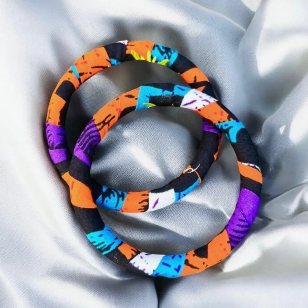 A pair of handmade multi-coloured bracelets for women