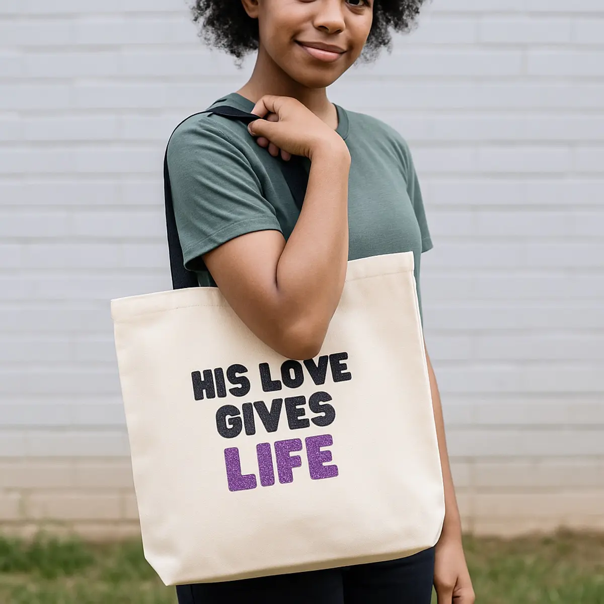 Someone wearing the inspirational tote bag