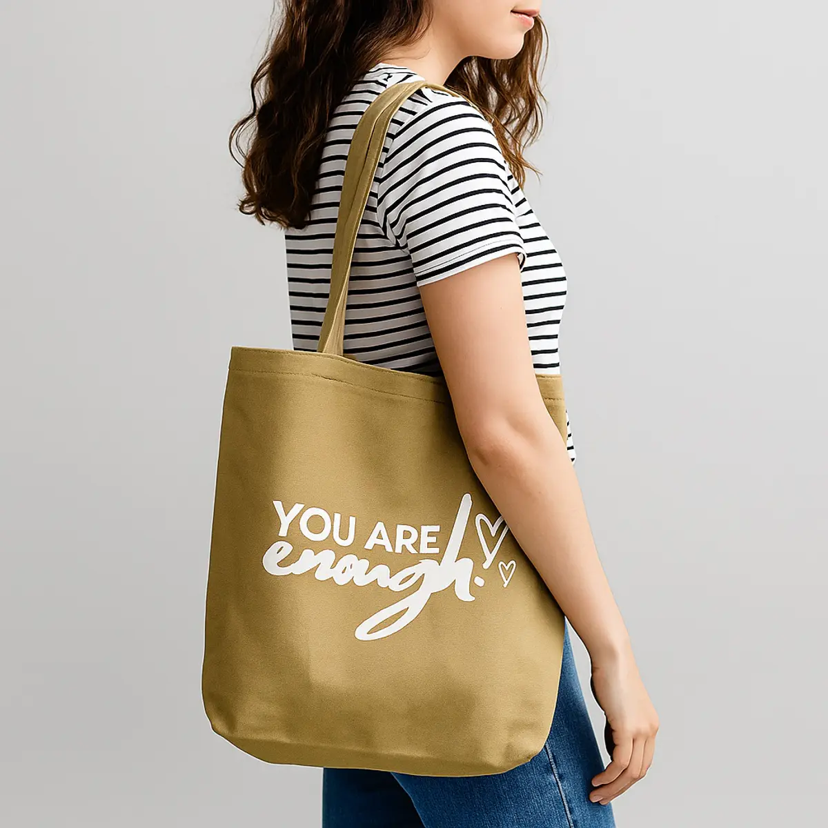 someone wearing an affirmation tote bag