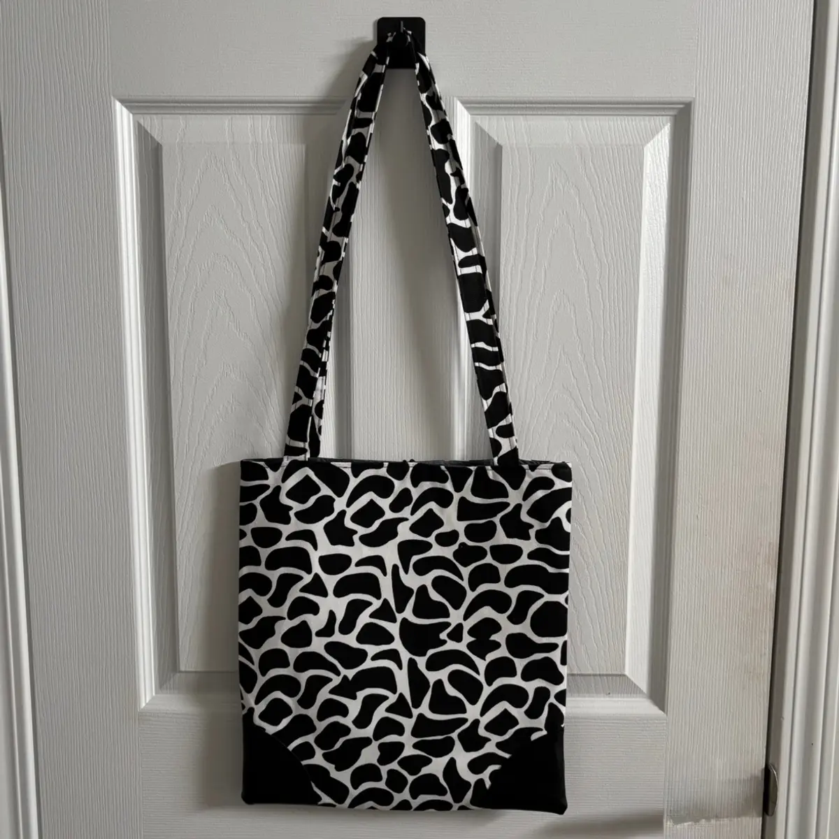 back view of this black and white animal print tote bag