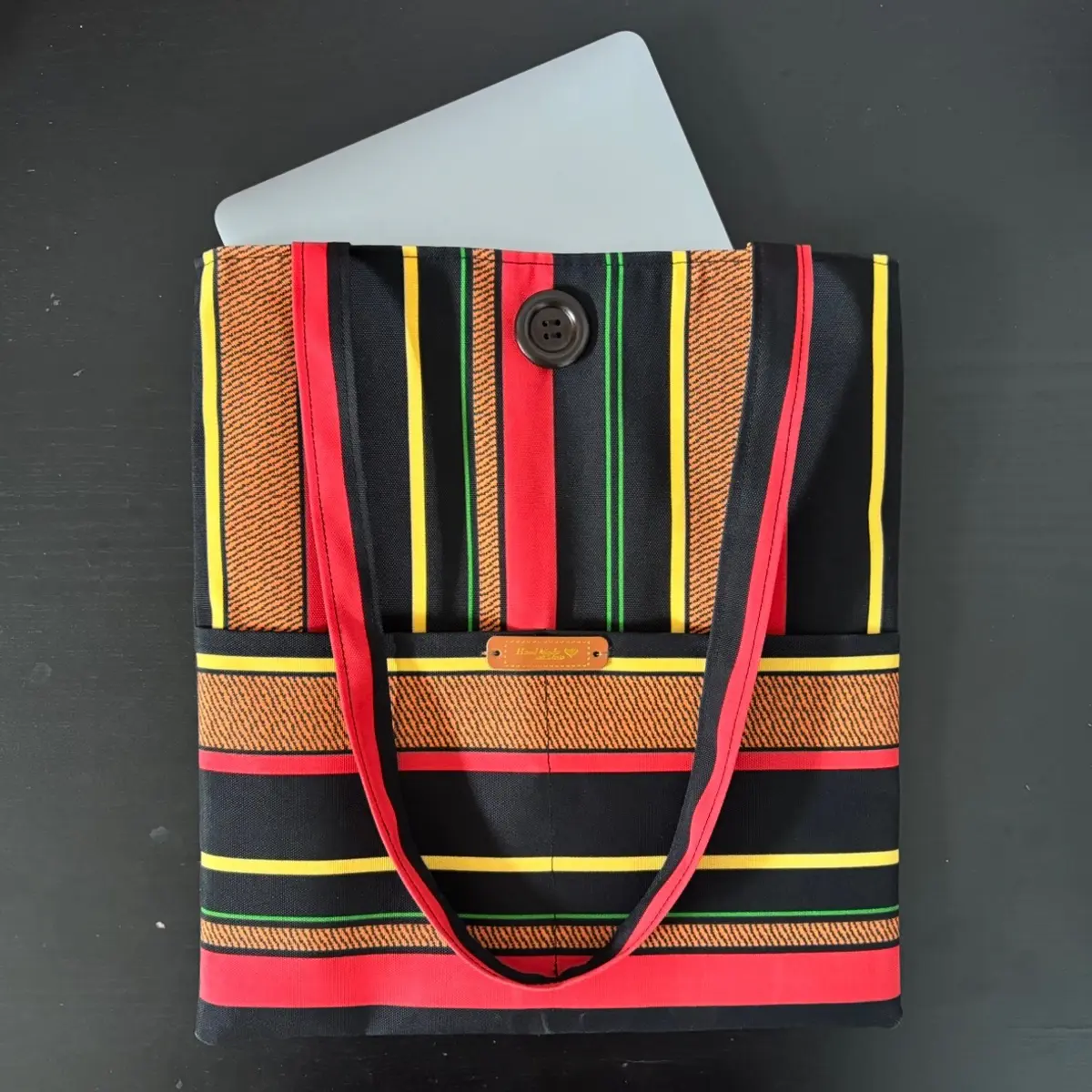 Showcasing a laptop fitting in the ankara tote bag