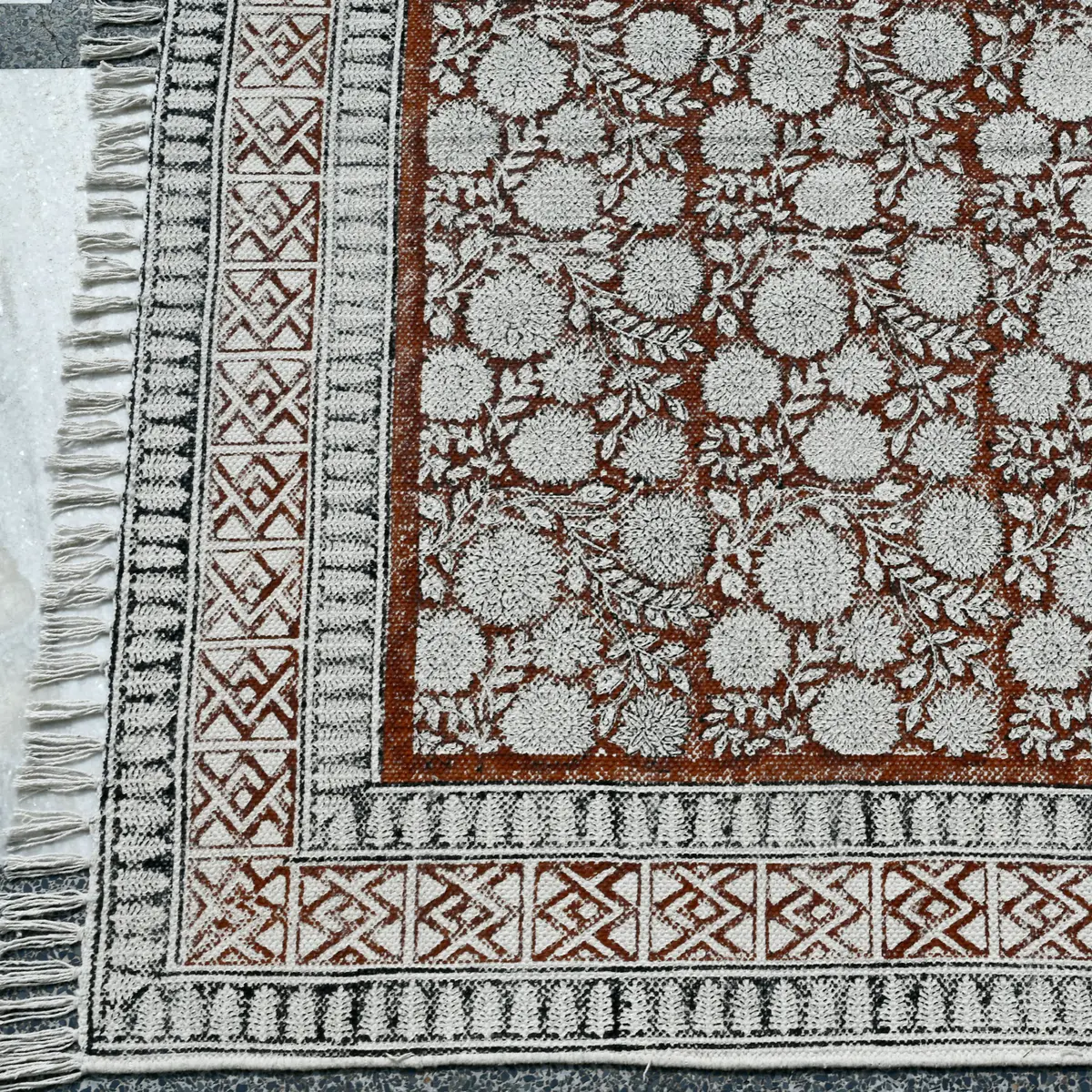 Shop handmade Indian cotton rugs crafted by skilled artisans. Boho, modern & durable area rugs for living rooms and bedrooms.