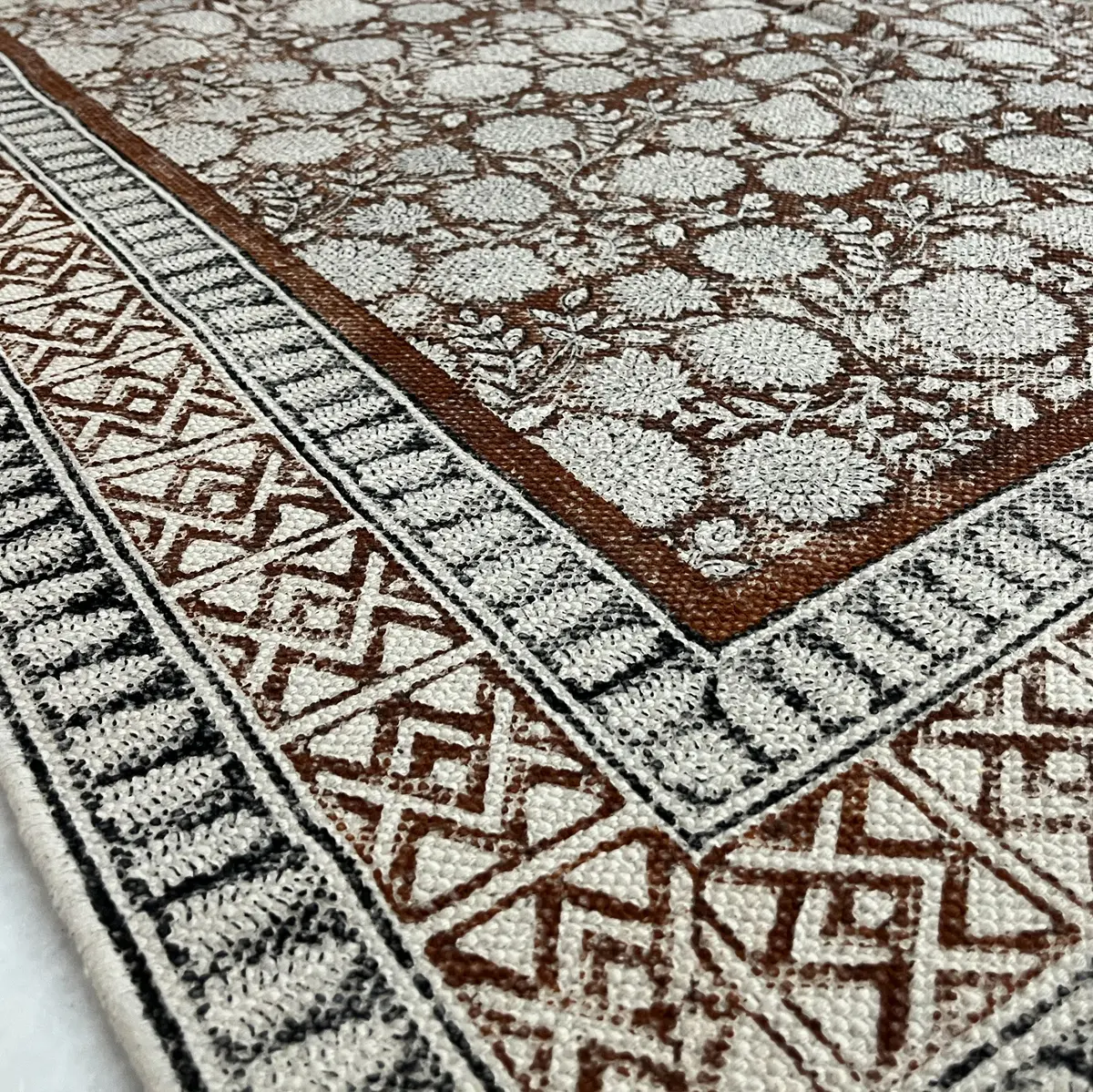 Shop handmade Indian cotton rugs crafted by skilled artisans. Boho, modern & durable area rugs for living rooms and bedrooms.