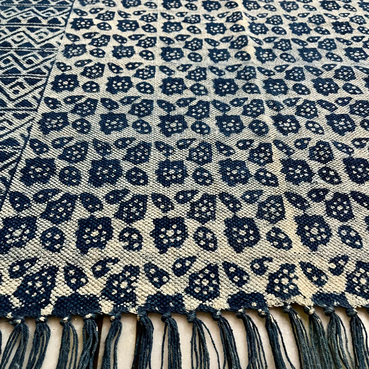 Shop handmade Indian cotton rugs crafted by skilled artisans. Boho, modern & durable area rugs for living rooms and bedrooms.