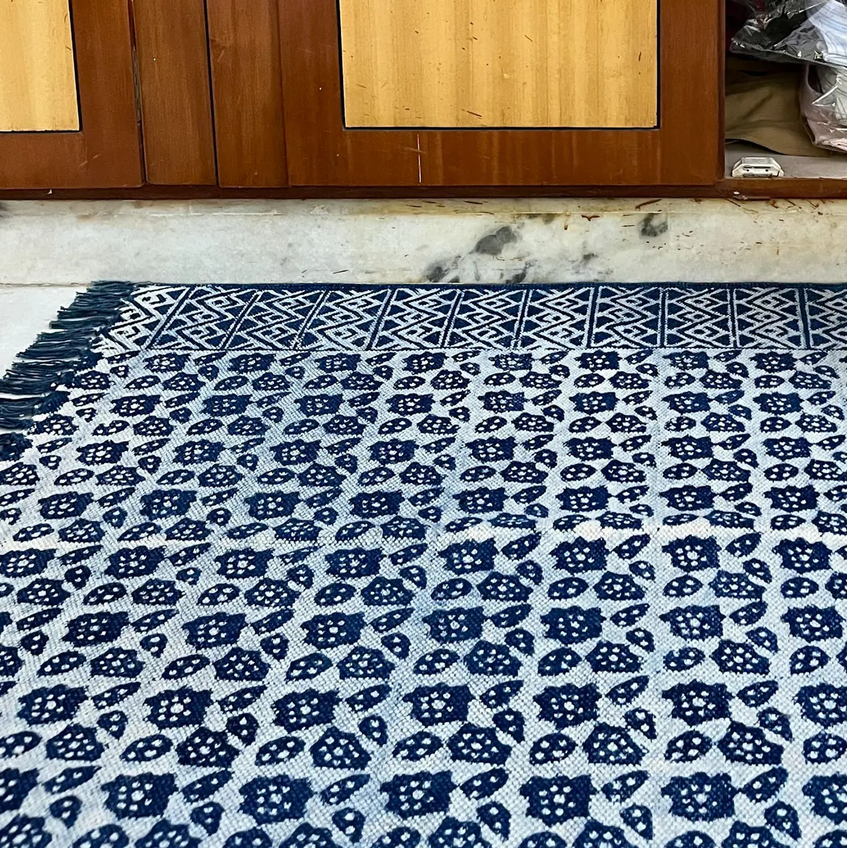 Shop handmade Indian cotton rugs crafted by skilled artisans. Boho, modern & durable area rugs for living rooms and bedrooms.