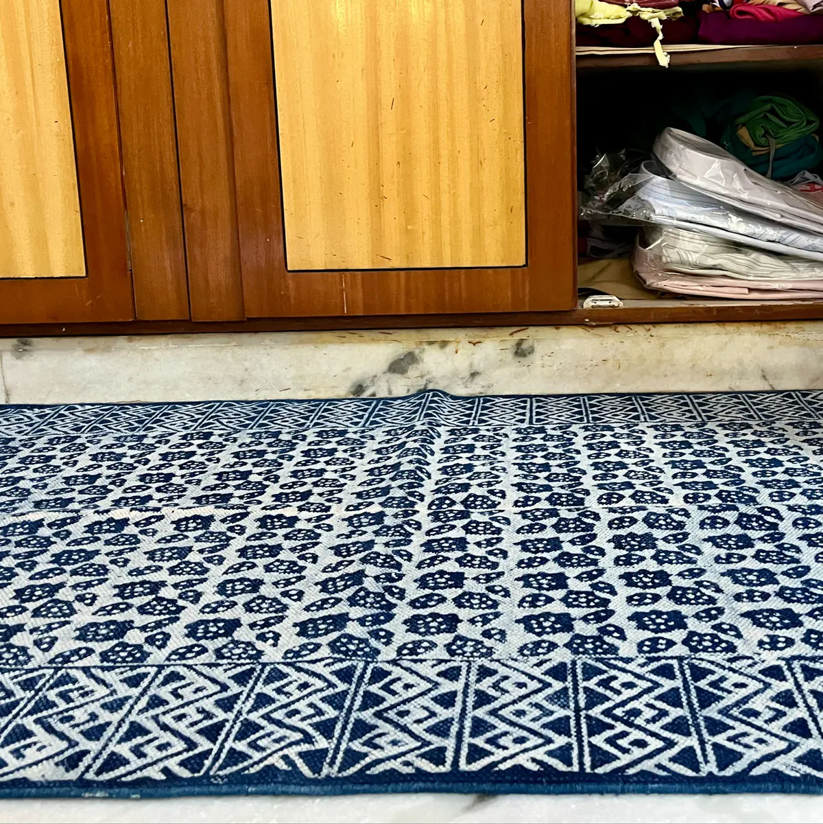 Shop handmade Indian cotton rugs crafted by skilled artisans. Boho, modern & durable area rugs for living rooms and bedrooms.