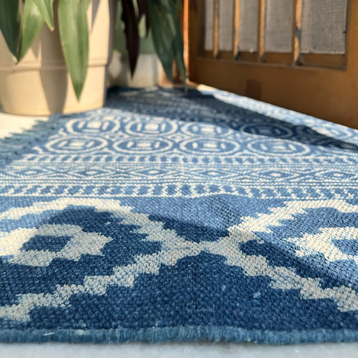 Shop handmade Indian cotton rugs crafted by skilled artisans. Boho, modern & durable area rugs for living rooms and bedrooms.