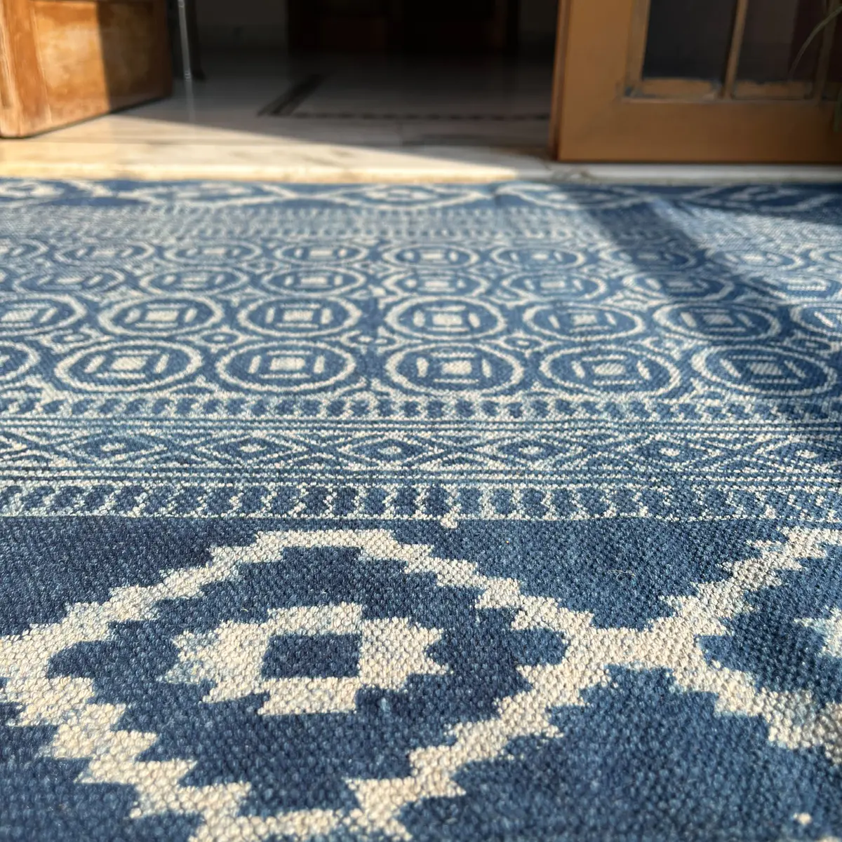 Shop handmade Indian cotton rugs crafted by skilled artisans. Boho, modern & durable area rugs for living rooms and bedrooms.