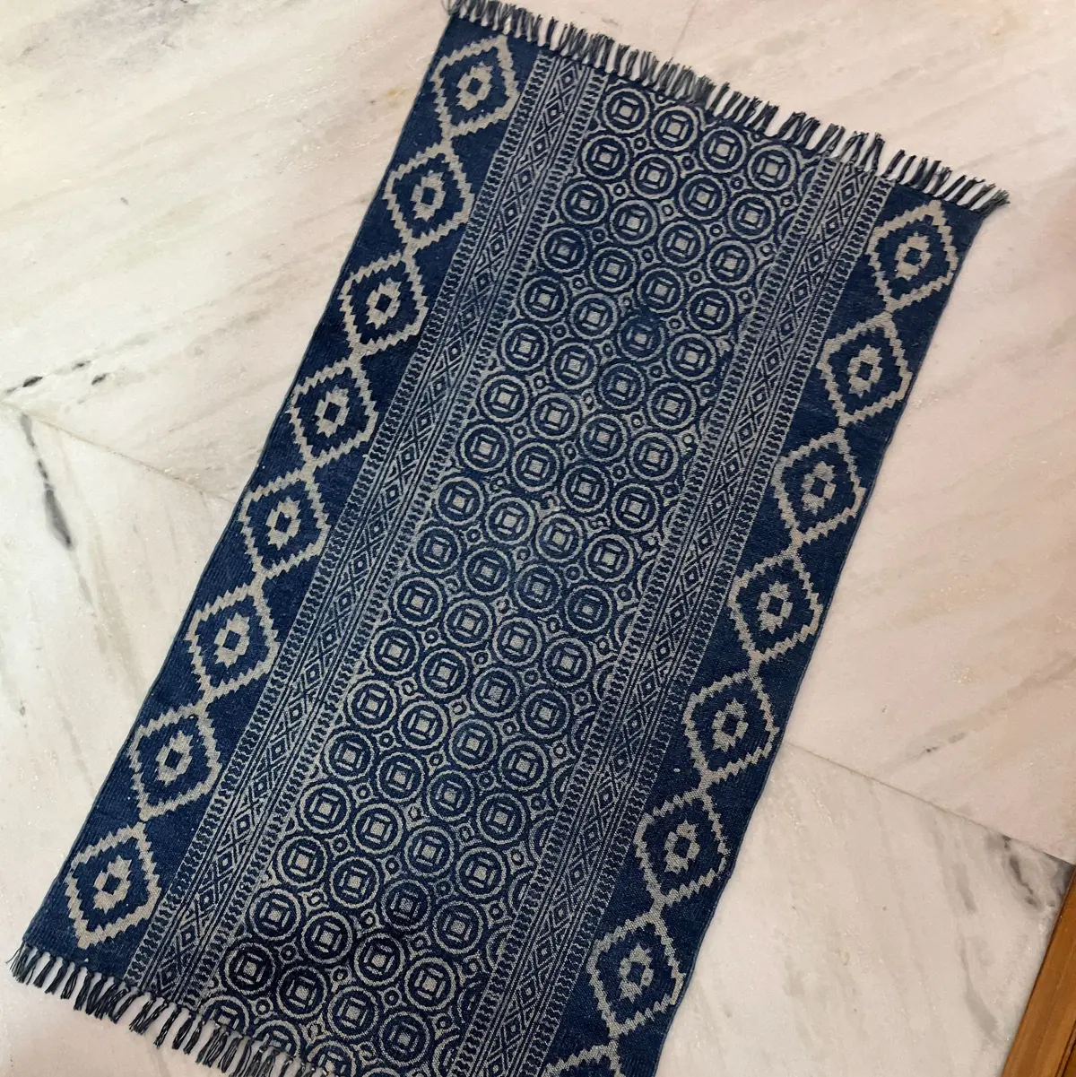 Shop handmade Indian cotton rugs crafted by skilled artisans. Boho, modern & durable area rugs for living rooms and bedrooms.