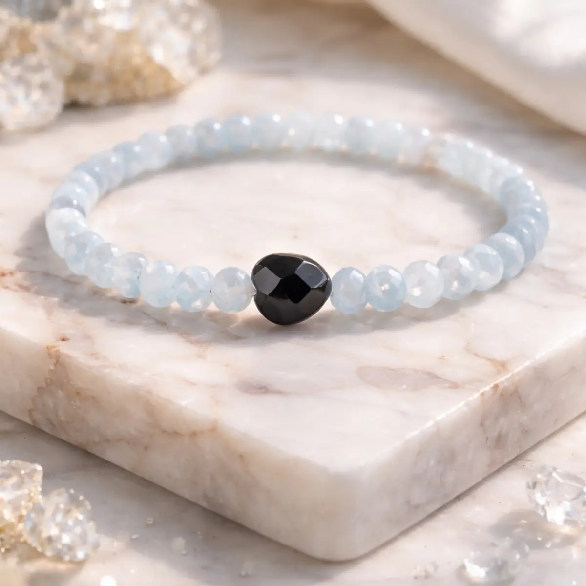 Light blue gemstone beaded bracelet with faceted black centerpiece, minimalist stretch crystal jewelry