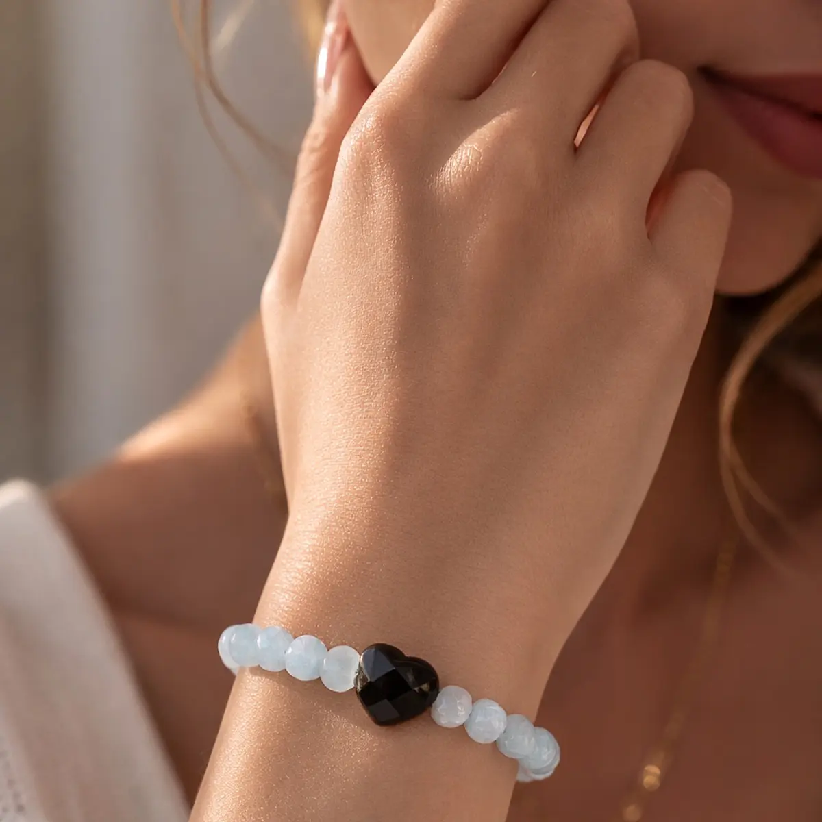 Light blue gemstone beaded bracelet with faceted black centerpiece, minimalist stretch crystal jewelry