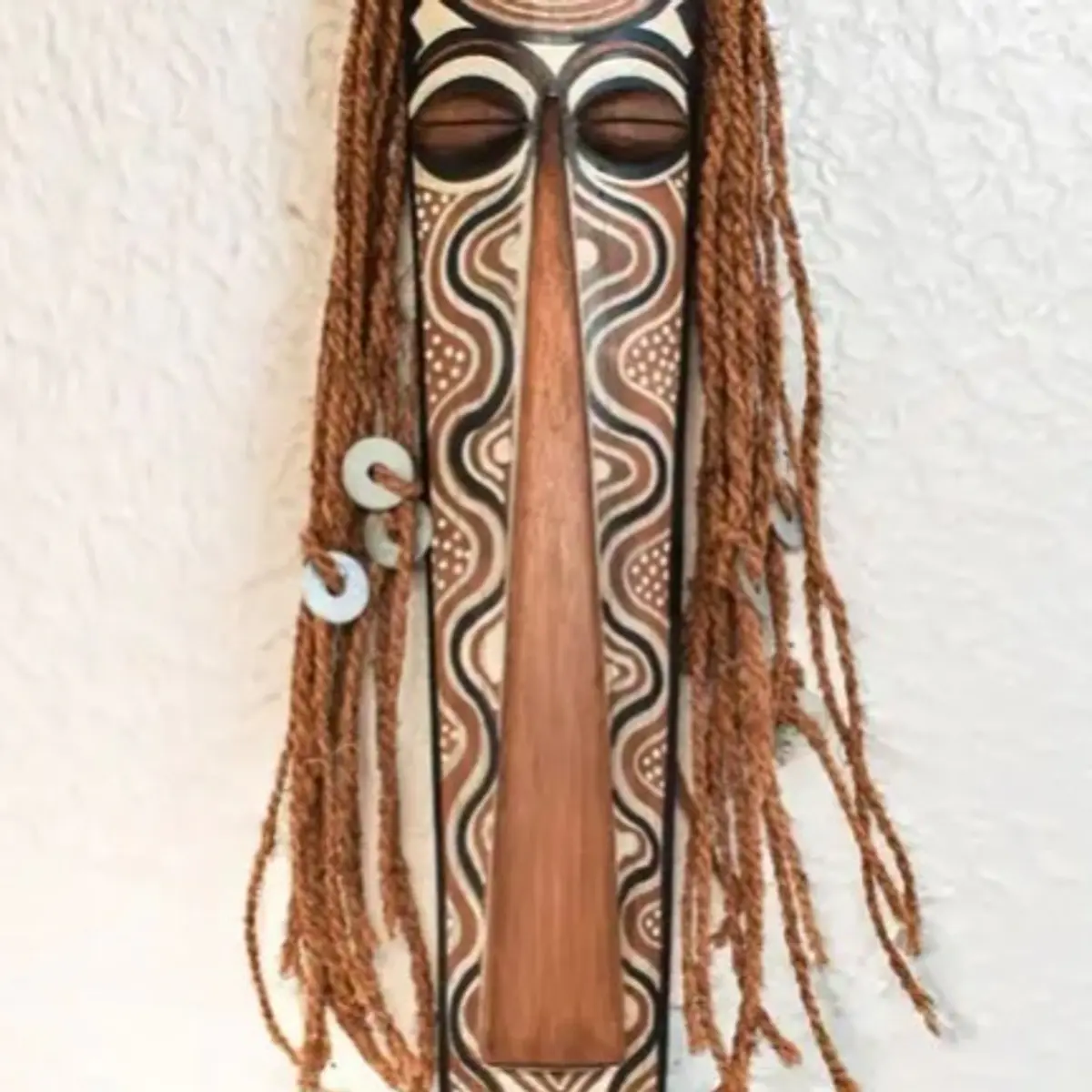 A tall hand-carved bamboo South Indian ritual mask featuring intricate tribal motifs, braided rope hair, and a sacred antelope totem