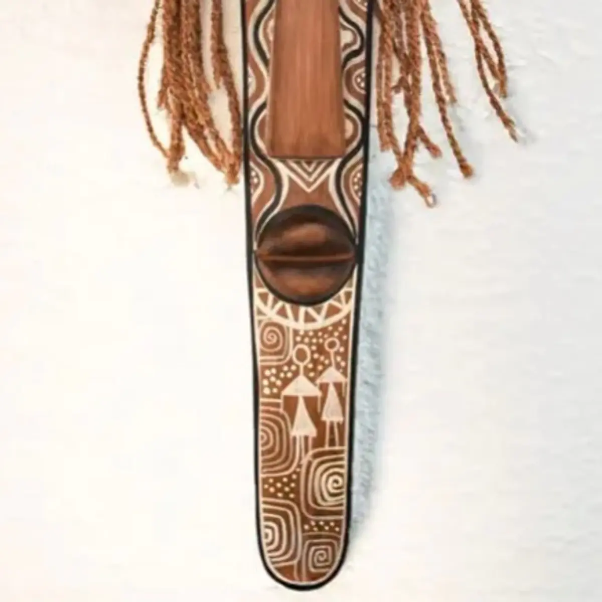 A tall hand-carved bamboo South Indian ritual mask featuring intricate tribal motifs, braided rope hair, and a sacred antelope totem