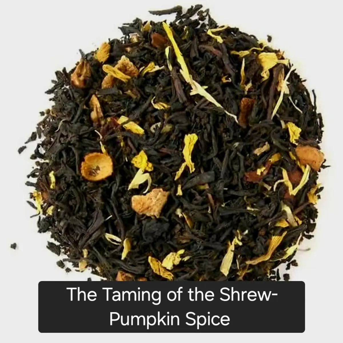 A close-up mound of loose-leaf pumpkin spice black tea blend, showing dark twisted tea leaves interspersed with golden marigold petals, dried orange peel pieces, and warm amber spice bits. The blend has a rich, deep brown and gold color palette evoking autumn warmth. Color: Dark Brown, Gold, Amber